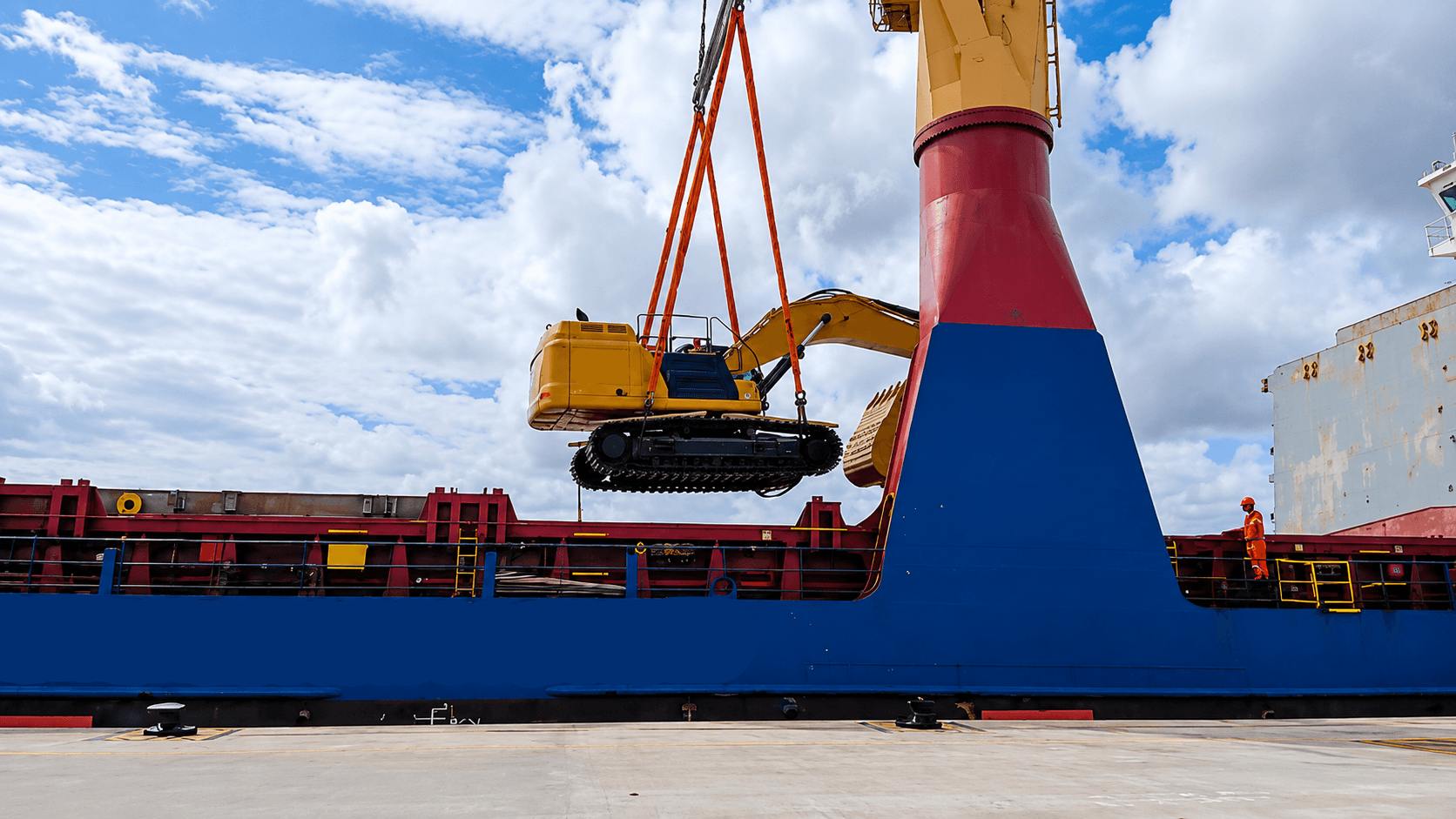 Excavator being lifted from a cargo vessel using coordinated rigging and crane operations.